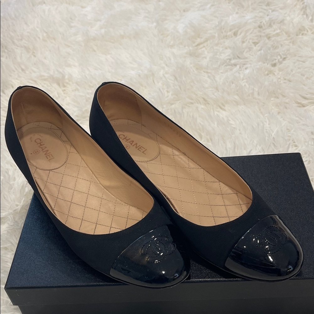Authentic Chanel black fabric shoe with 1.5” heel. Patent toe with CC logo. $725